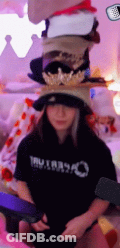 Woman In Black Shirt Saying Tru Stacking Hats GIF