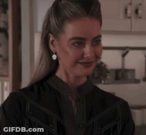 Woman In Black Shirt Smiling With Earrings GIF