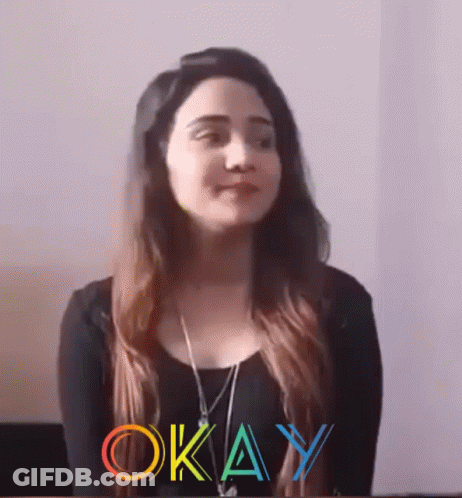 Woman In Black Shirt Standing Before Okay Sign GIF