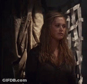 Woman In Black Shirt Standing In Dark Room GIF