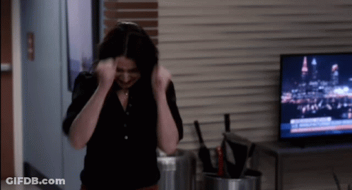 Woman In Black Shirt Standing In Front Of Flat Screen TV GIF