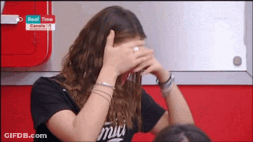 Woman In Black Shirt With Amici Covering Face GIF