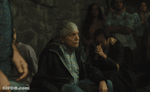 Woman In Black Shirt With Daisies In Crowd GIF
