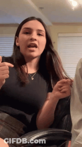 Woman In Black Shirt With P Necklace GIF