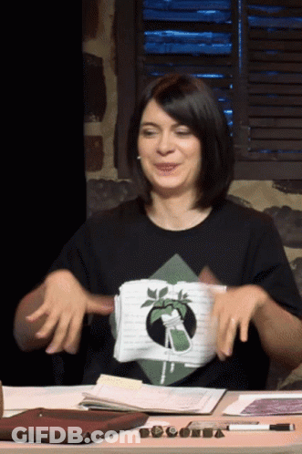 Woman In Black Shirt With Plant Sitting At Desk GIF