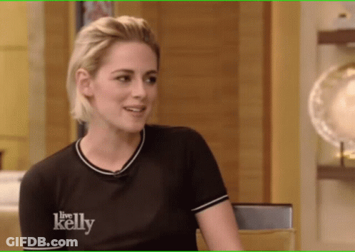 Woman In Black Shirt With Square Pendant Necklace GIF