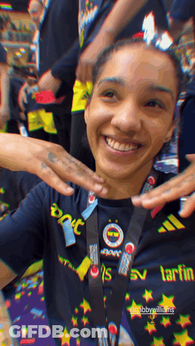 Woman In Black Shirt With Tart Lanyard GIF