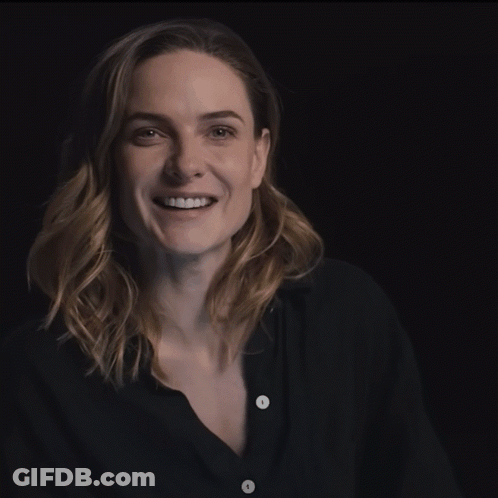 Woman In Black Shirt With White Buttons Smiling GIF
