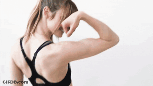 Woman In Black Sports Bra Stretching Arm GIF