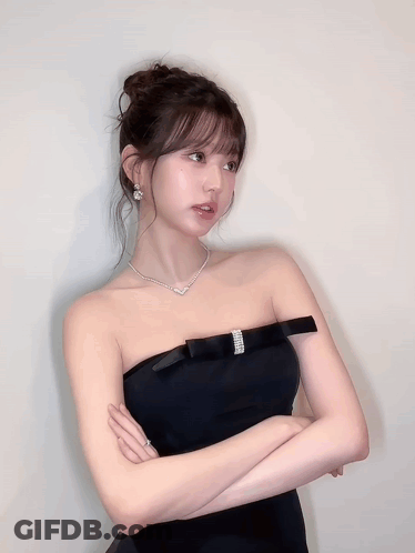 Woman In Black Strapless Dress With Eyes Closed GIF