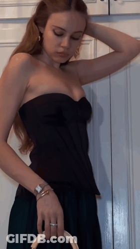 Woman In Black Strapless Top And Watch GIF