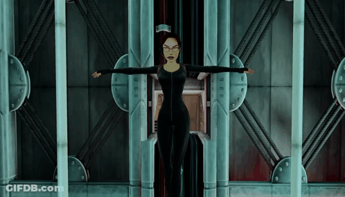 Woman In Black Suit And Glasses With Arms Outstretched In Elevator GIF