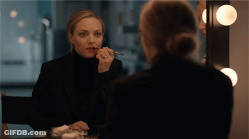 Woman In Black Suit Applying Lipstick GIF
