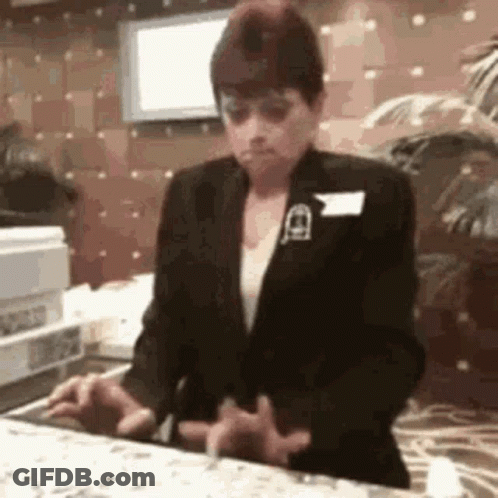 Woman In Black Suit At Restaurant Counter GIF