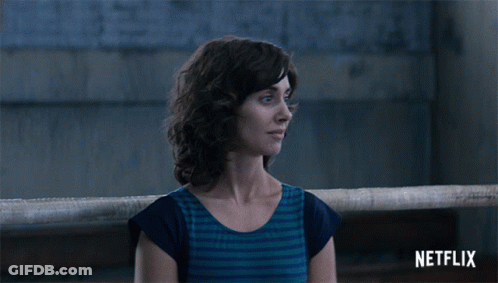 Woman In Black Suit Dancing Before Points Of Impact Board GIF