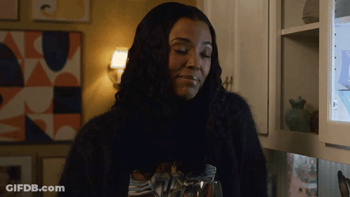 Woman In Black Sweater Holding Glass Of Water GIF