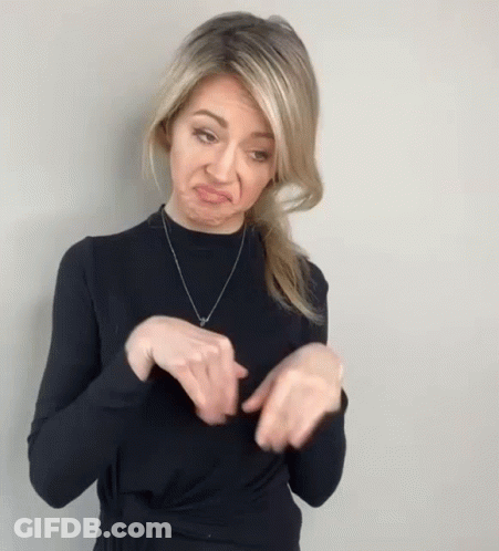 Woman In Black Sweater Making Funny Face With Hands GIF