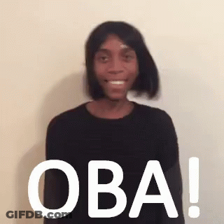 Woman In Black Sweater Wig Smiling Owa Sign GIF