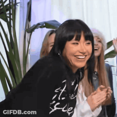 Woman In Black Sweatshirt Smiling Beside Group Of Women GIF