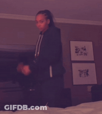 Woman In Black Sweatshirt With Letter A Holding Green Bottle GIF