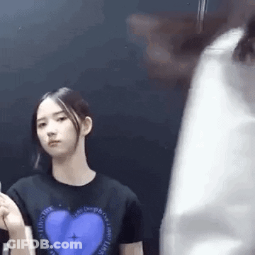 Woman In Black T-Shirt With Blue Heart Next To Man GIF