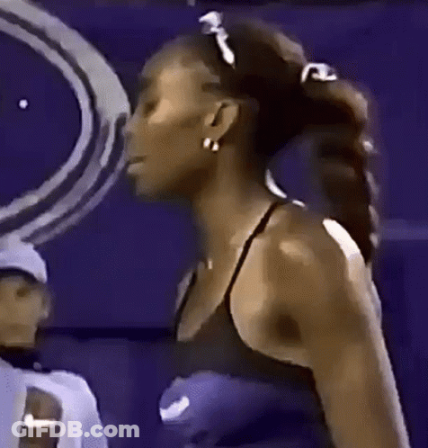 Woman In Black Tank Top And Earrings Against Purple Background GIF