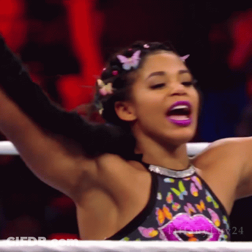 Woman In Black Tank Top And Gold Hoop Earrings Smiling GIF