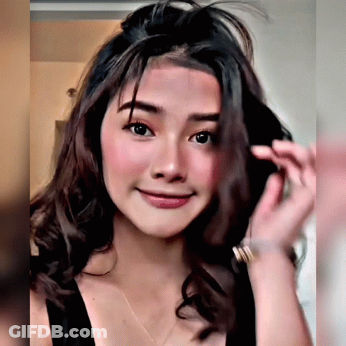 Woman In Black Tank Top Holding Hair GIF