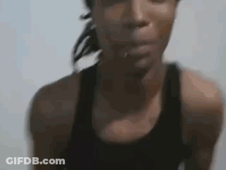 Woman In Black Tank Top Looking At Camera GIF