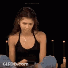 Woman In Black Tank Top Looking At Phone GIF