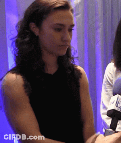 Woman In Black Tank Top Looking Down GIF