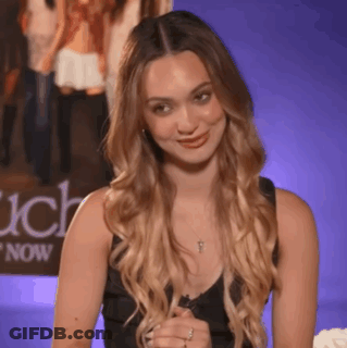 Woman In Black Tank Top Smiling In Front Of Each Now Poster GIF