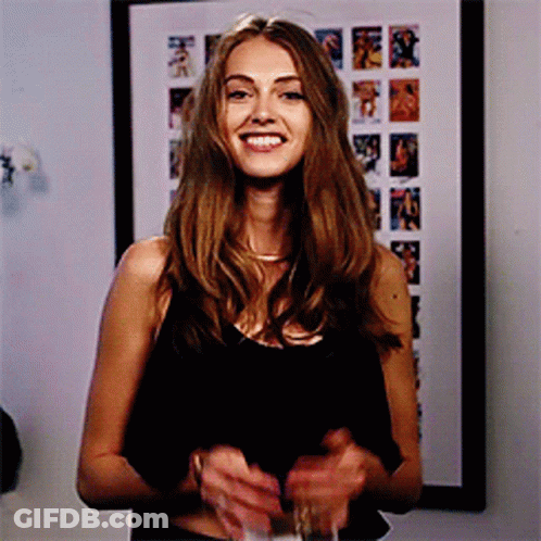 Woman In Black Tank Top Smiling With Wine GIF