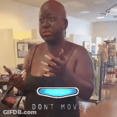 Woman In Black Tank Top Standing By 'Don't Move' Sign GIF