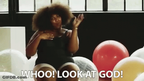 Woman In Black Tank Top Surrounded By Balloons GIF