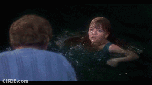 Woman In Black Tank Top Swimming In Ocean GIF