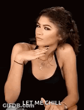 Woman In Black Tank Top With Hand On Chin GIF