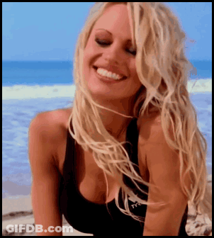 Woman In Black Tank Top With Letter T Smiling GIF