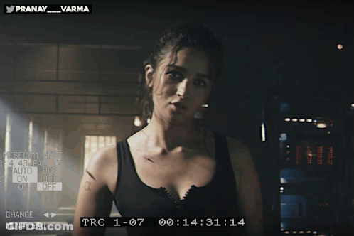 Woman In Black Tank Top With Pranay Varma On Screen GIF