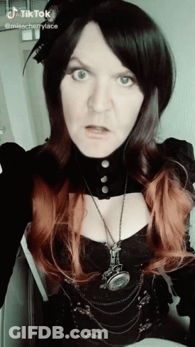 Woman In Black Top And Necklace With TikTok GIF