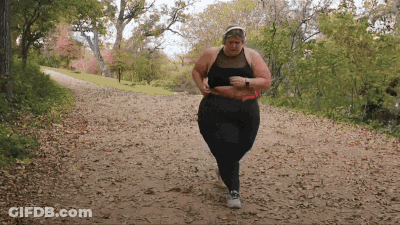 Woman In Black Top And Pants Running Down Dirt Path GIF