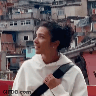 Woman In Black Top And Pants Standing In Front Of Mirror GIF