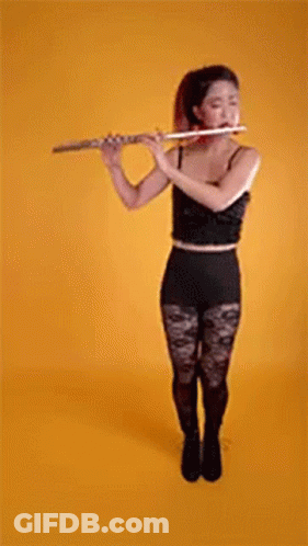 Woman In Black Top And Tights Playing Flute GIF