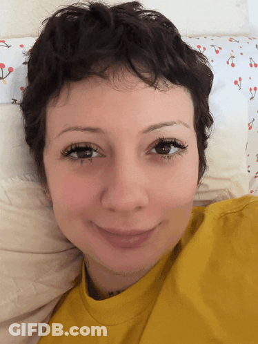Woman In Black Top Saying Gerl Making Heart Shape GIF