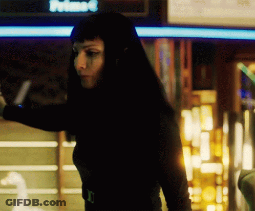 Woman In Black Top Standing In Front Of Prime Sign GIF