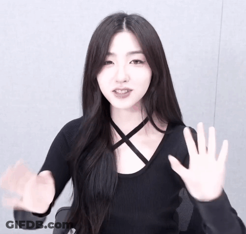 Woman In Black Top Waving GIF