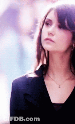 Woman In Black Top With Pendant Necklace GIF