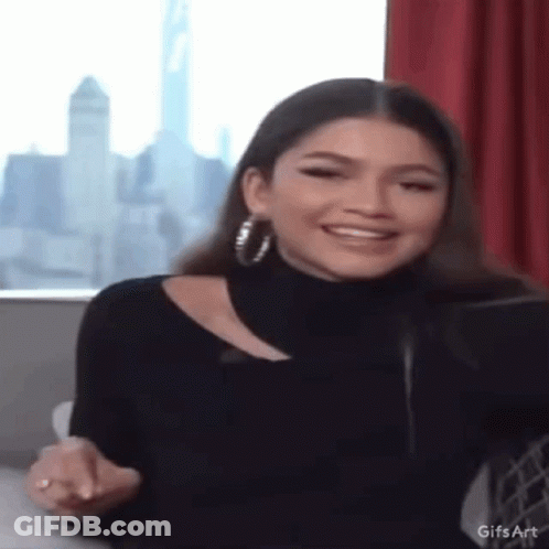 Woman In Black Turtleneck And Hoop Earrings GIF