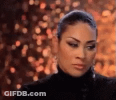 Woman In Black Turtleneck Looking At Camera GIF