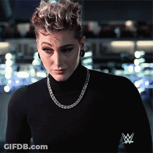Woman In Black Turtleneck With Wrestling Logo GIF